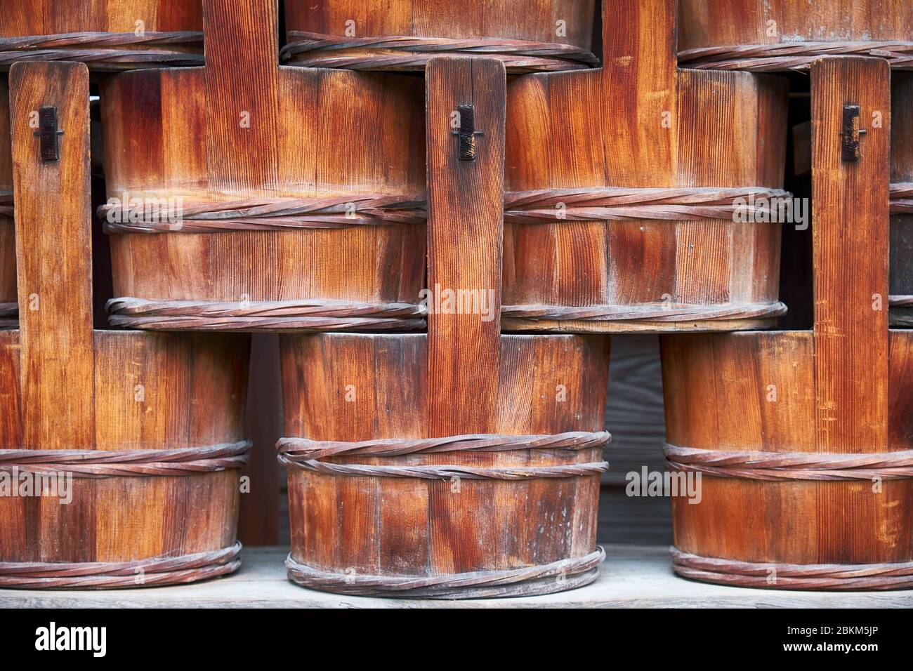 The the close up view of the old traditional Japanese sawara cypress wooden bucket at the Kinkaku-ji Temple. Kyoto. Japan Stock Photo