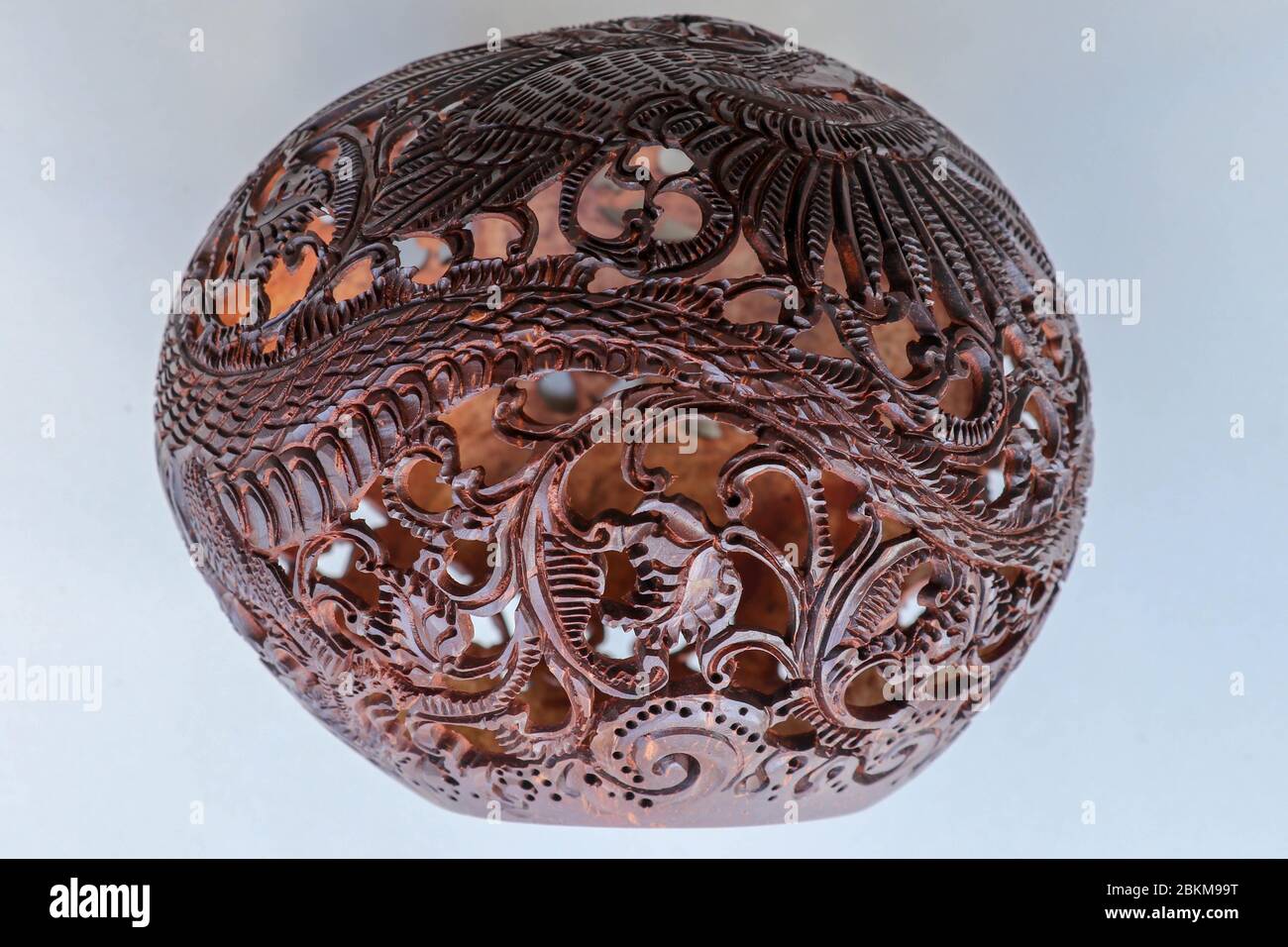 Close up ornamental shell for candle. Carved Souvenir from Coconut