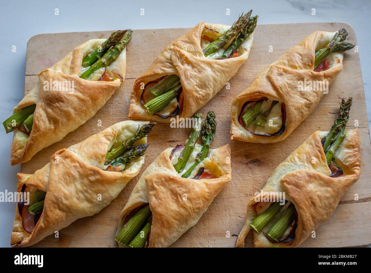 Asparagus baked in puff pastry with ham and cheese Stock Photo Alamy