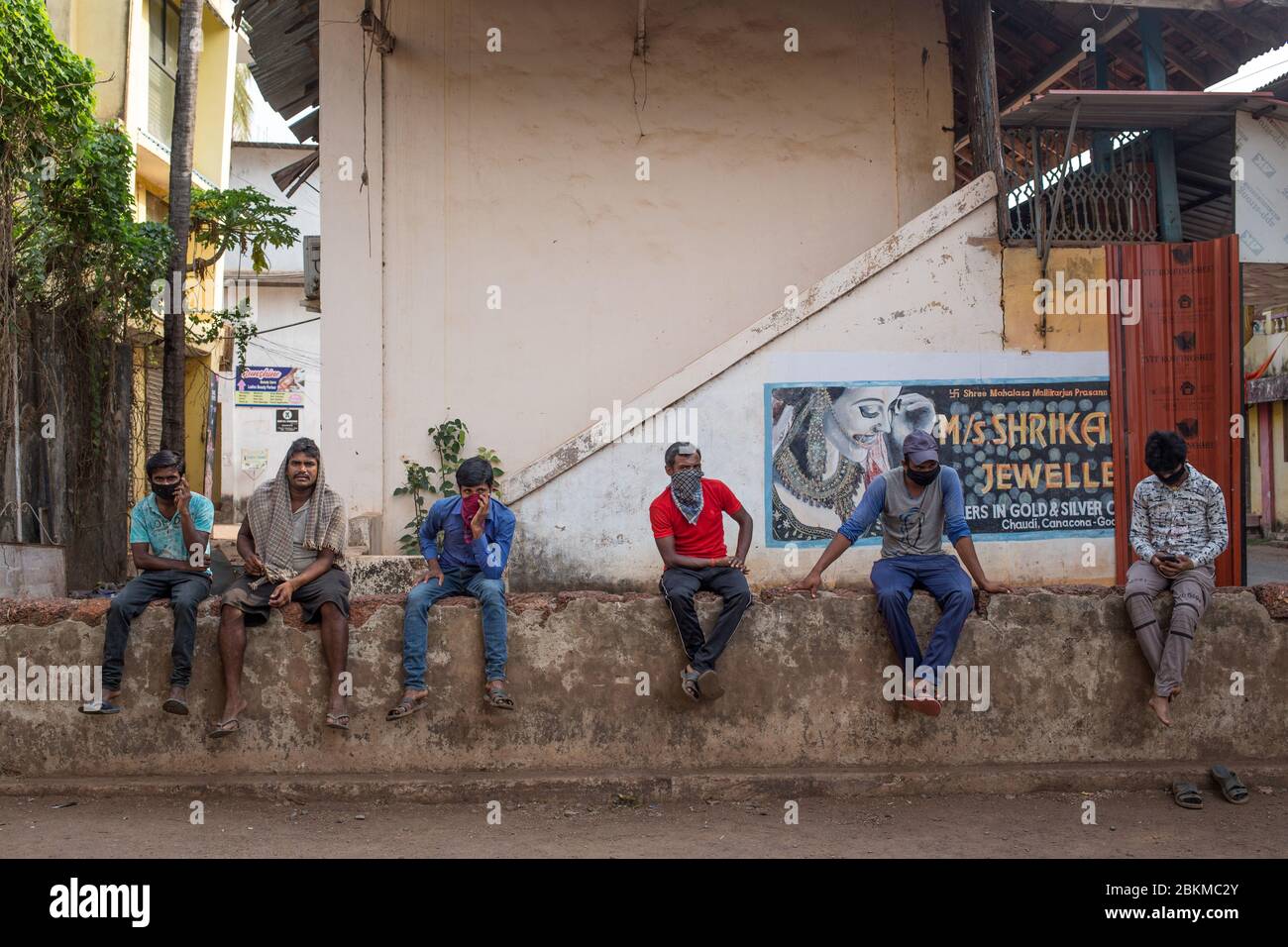 Day labour workers sitting without jobs waiting in the morning in south India. Stock Photo