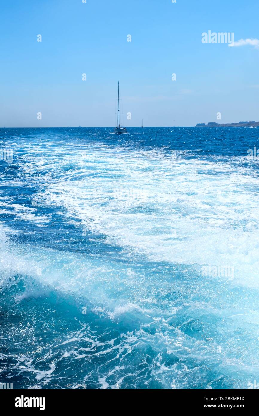 Trail on water surface behind of fast moving motor boat Stock Photo - Alamy