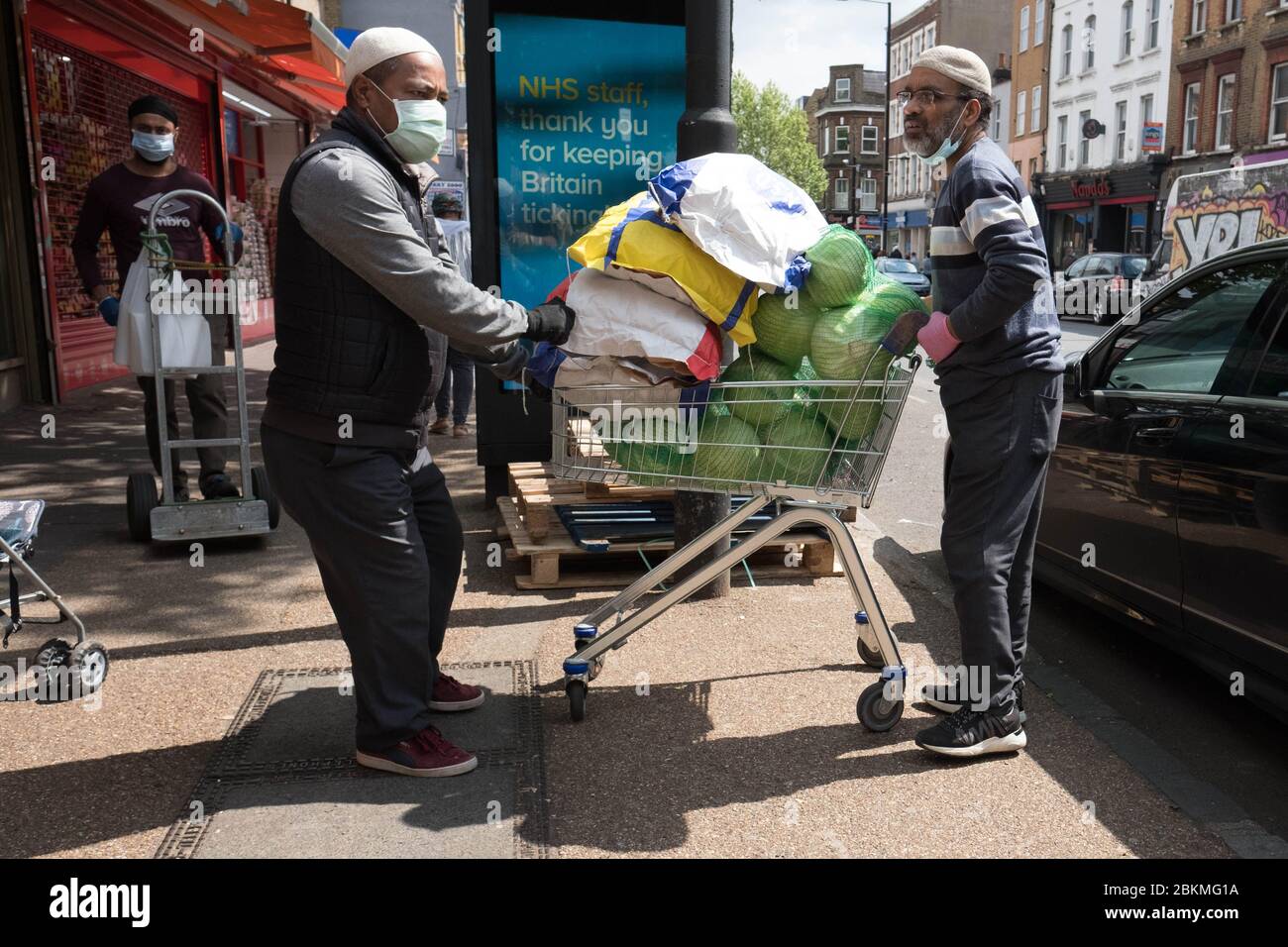 Members of the Islamic community in Bethnal Green, east London go about their daily business during the holy month of Ramadan as the UK continues in lockdown to help curb the spread of the coronavirus. Stock Photo