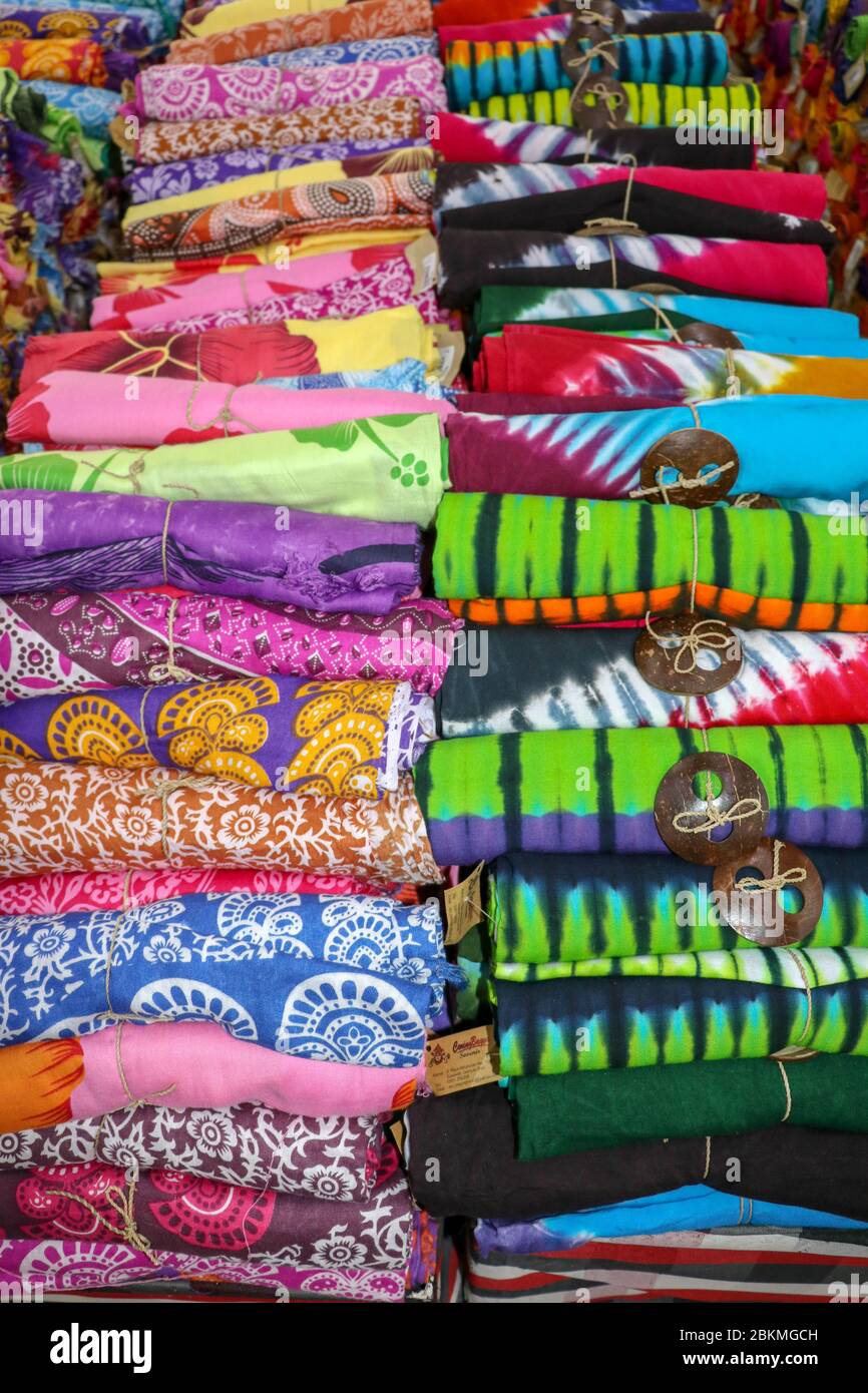 Batik cloth cloth for sale rolled up in market. Balinese art and culture. Close up of rolled colorful sarong. Colorful fabric rolls. Traditional Hindu Stock Photo