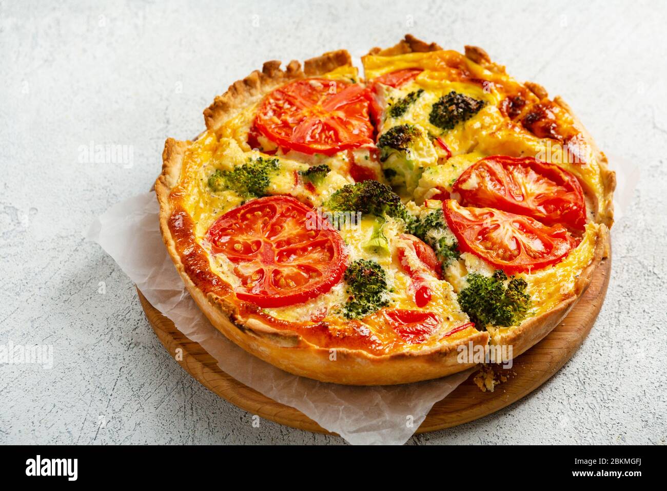 Quiche lorraine with broccoli and cheese on  cutting board, food close up Stock Photo