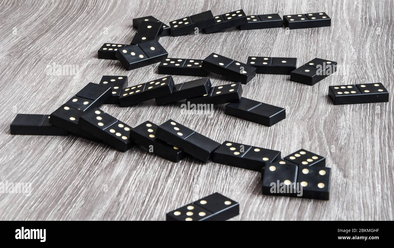 Black Dominoes game block in a row on a colored background Stock Photo -  Alamy