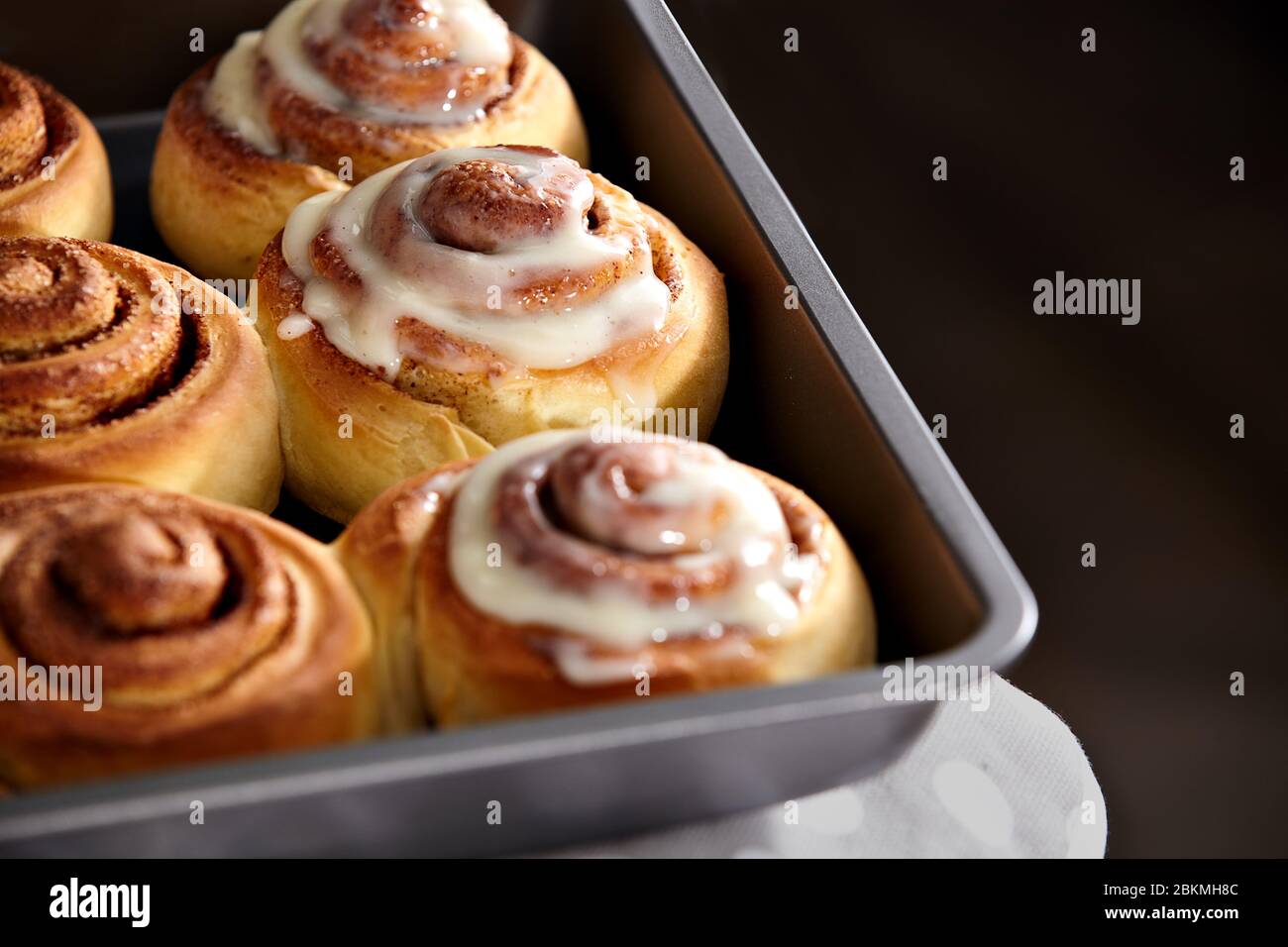 Fresh bakery. Cinnamon rolls are oiled. Homemade cinnabon close up