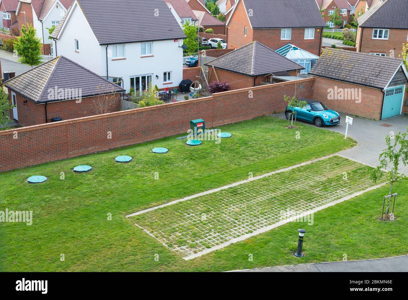 Calor propane gas tanks buried in the ground of a new housing estate with driveway for lorry, kent, uk Stock Photo