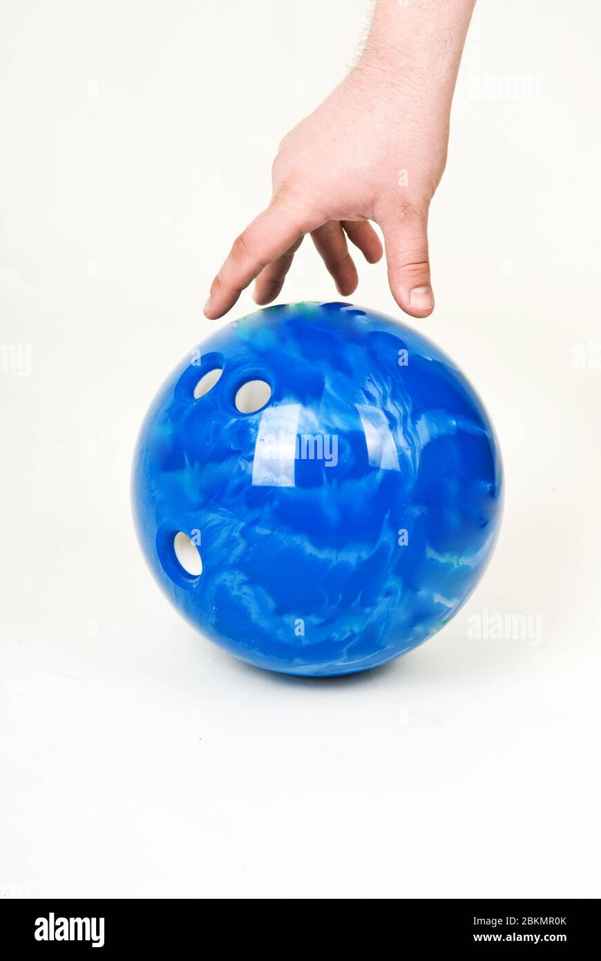 Hand and bowling ball on a white background Stock Photo