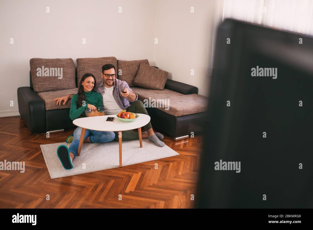 Couple is relaxing at home. They are watching tv Stock Photo - Alamy