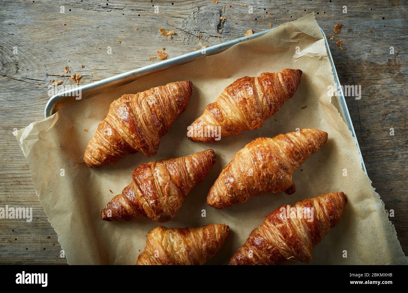 freshly baked croissants on baking pan, top view Stock Photo