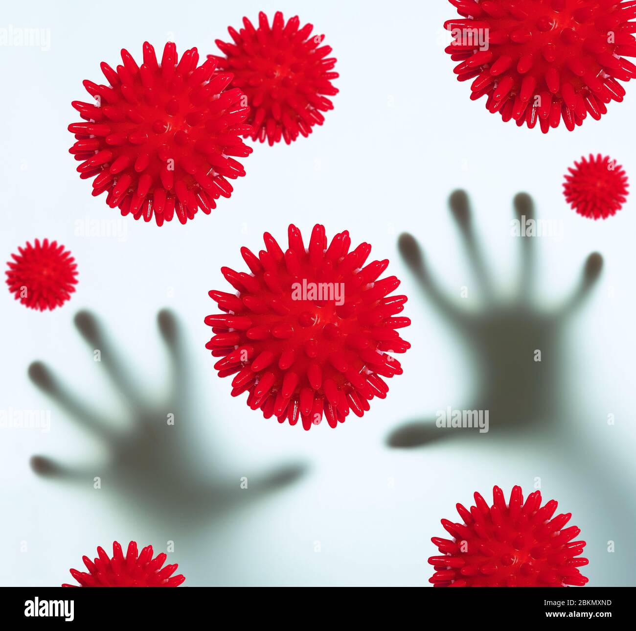 blurry human arms with coronavirus symbols Stock Photo