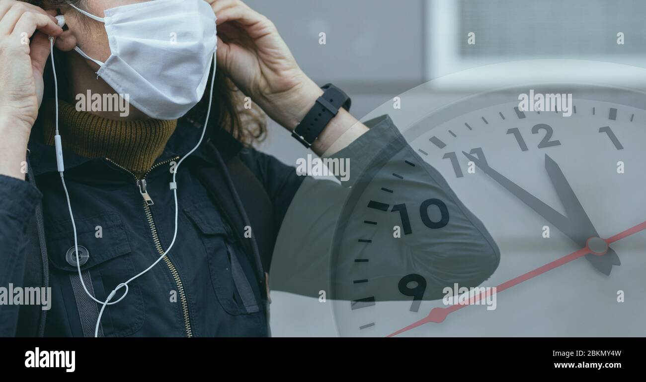 Digital illustration of a woman wearing a face mask putting her earphones on over a clock Stock Photo