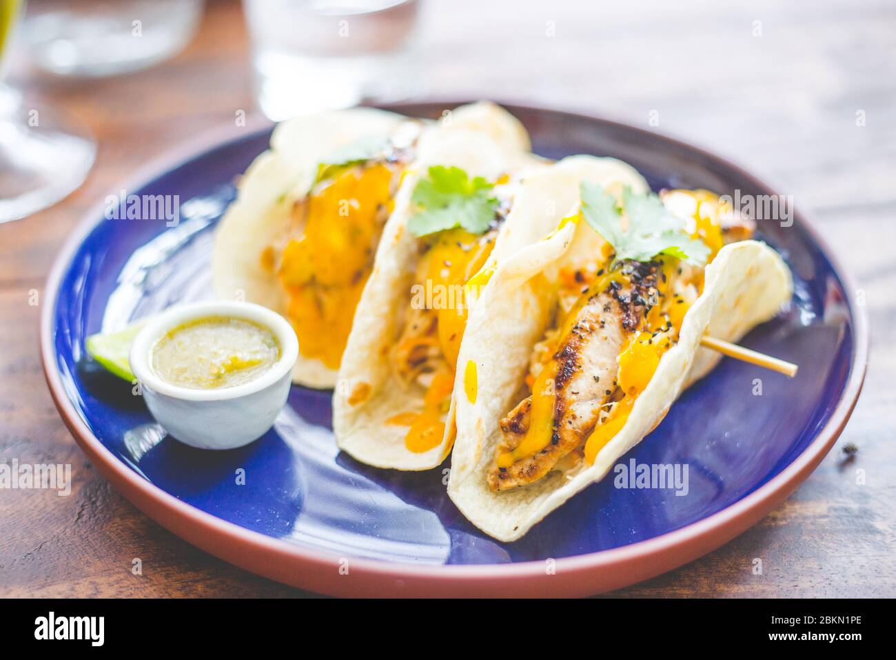 Testy tuna fish tacos with tropical fruit sauce, lemon zest and
