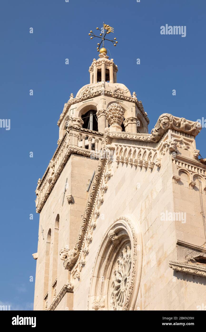 The st Mark church at the town of Korcula island, Dalmatia, Croatia. The beautiful rosette with gothic elements and a blue sky on a sunny day. Old arc Stock Photo