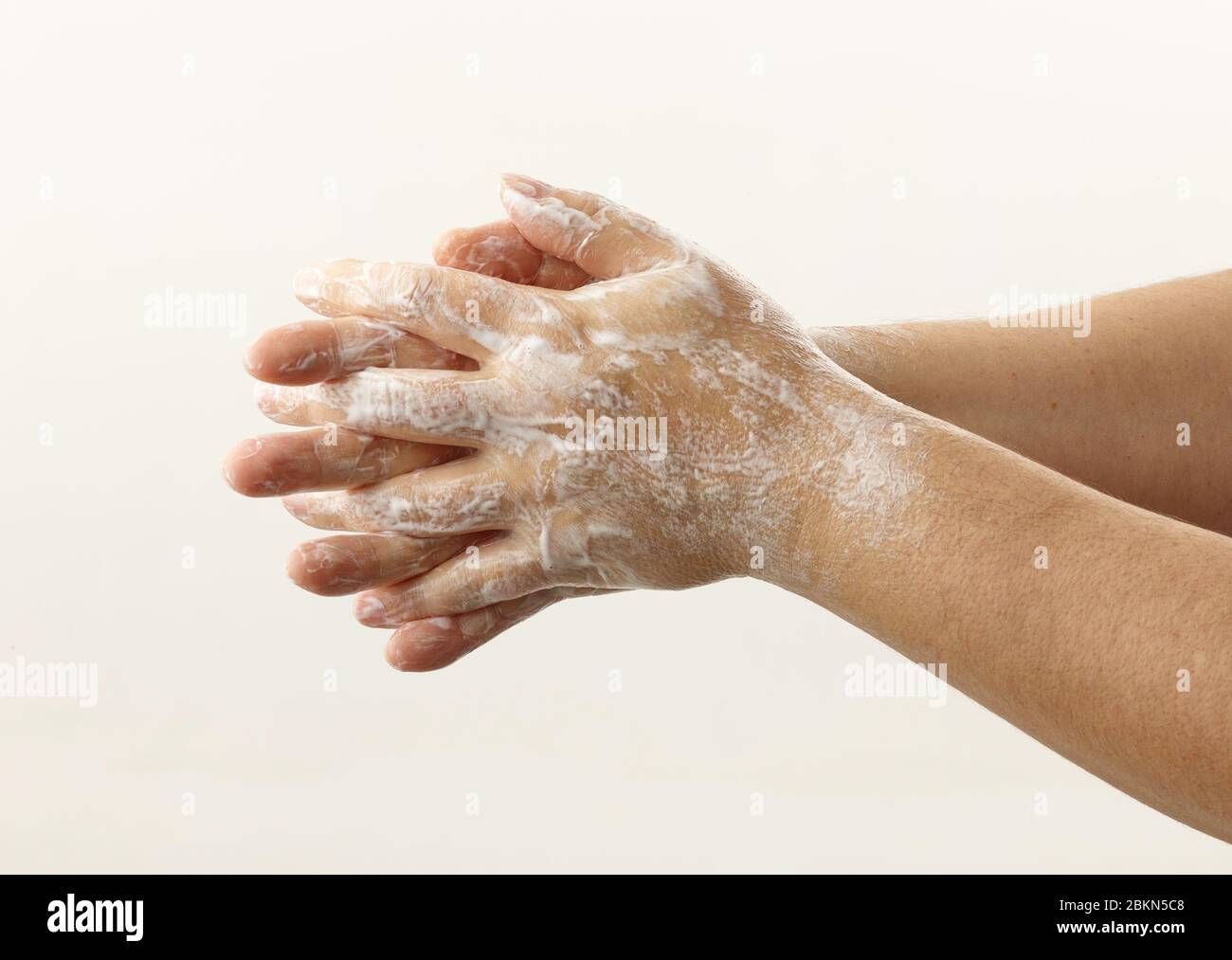 hands with soap foam on white background Stock Photo