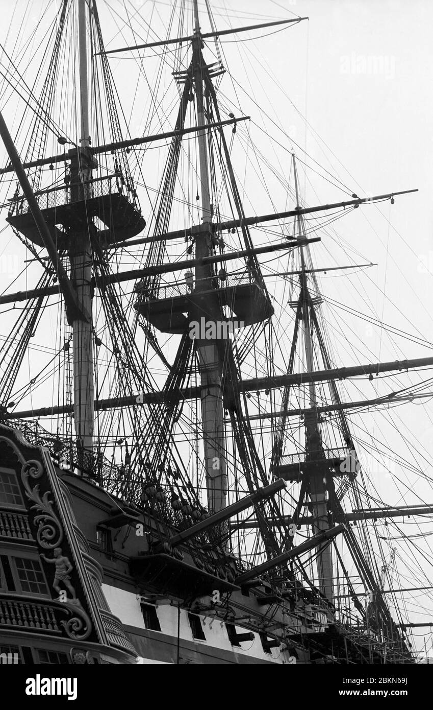 H.M.S. Victory, No. 2 Dry Dock, Portsmouth Historic Dockyard: view from the starboard quarter showing masts and rigging before the removal of the topmasts for restoration in 2011. Black and white film photograph Stock Photo