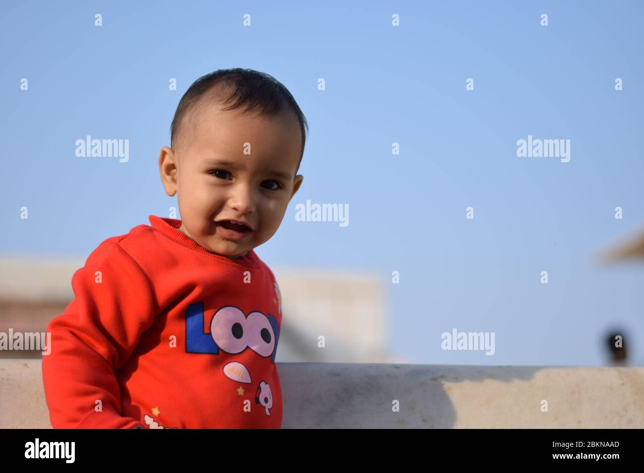 portrait of a cute little girl smiling against clear sky Stock Photo ...