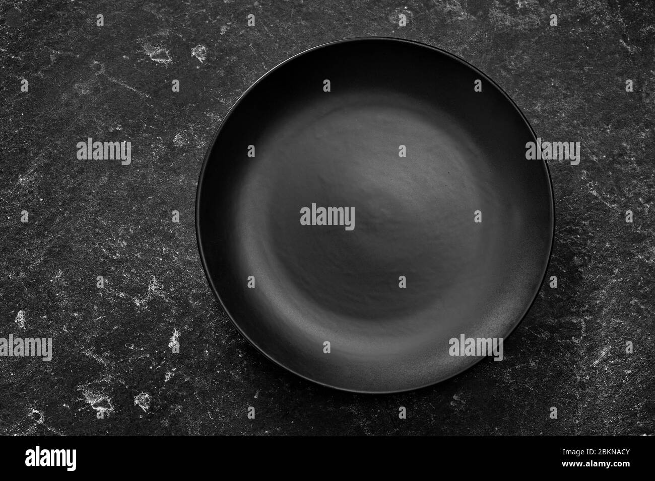 Top view of a black plate on dark background Stock Photo