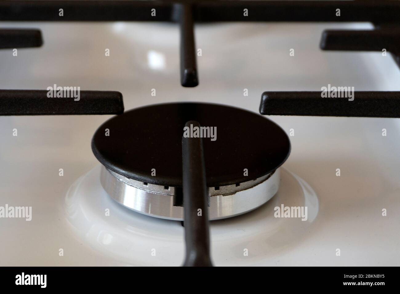 gas ring on the stove with cast iron grate . Stock Photo