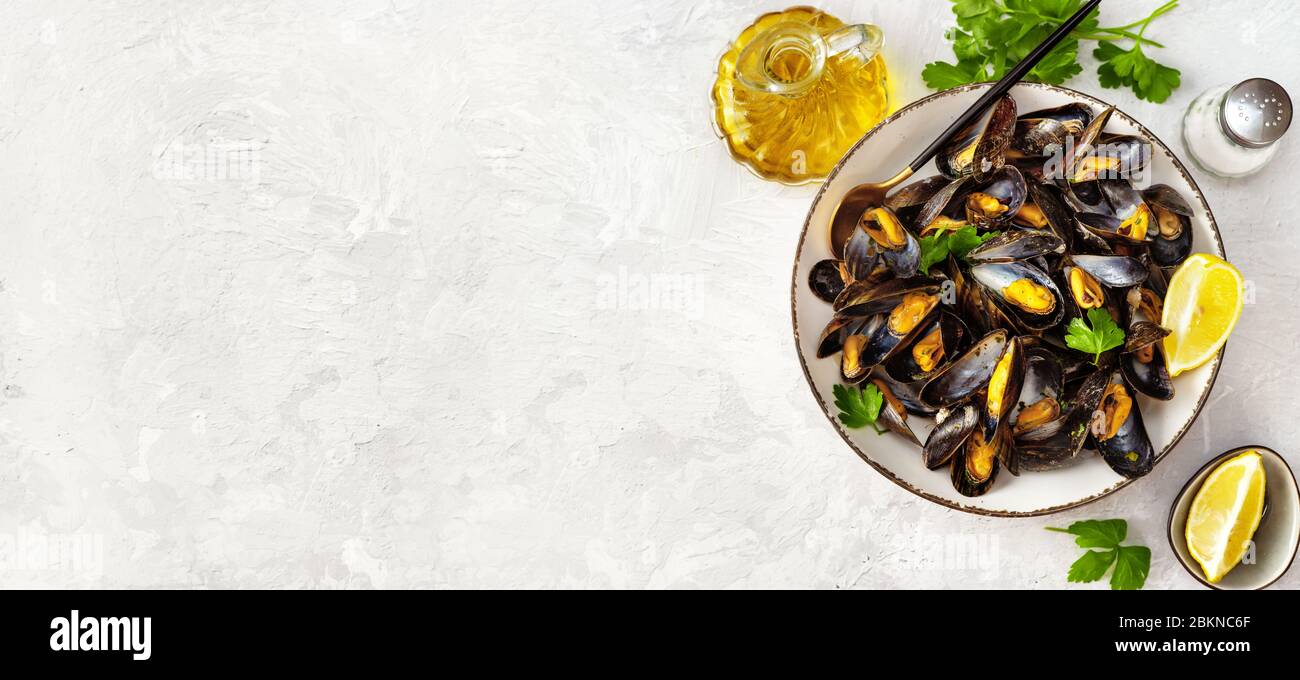 Delicious and healthy steamed mussels on white background Stock Photo