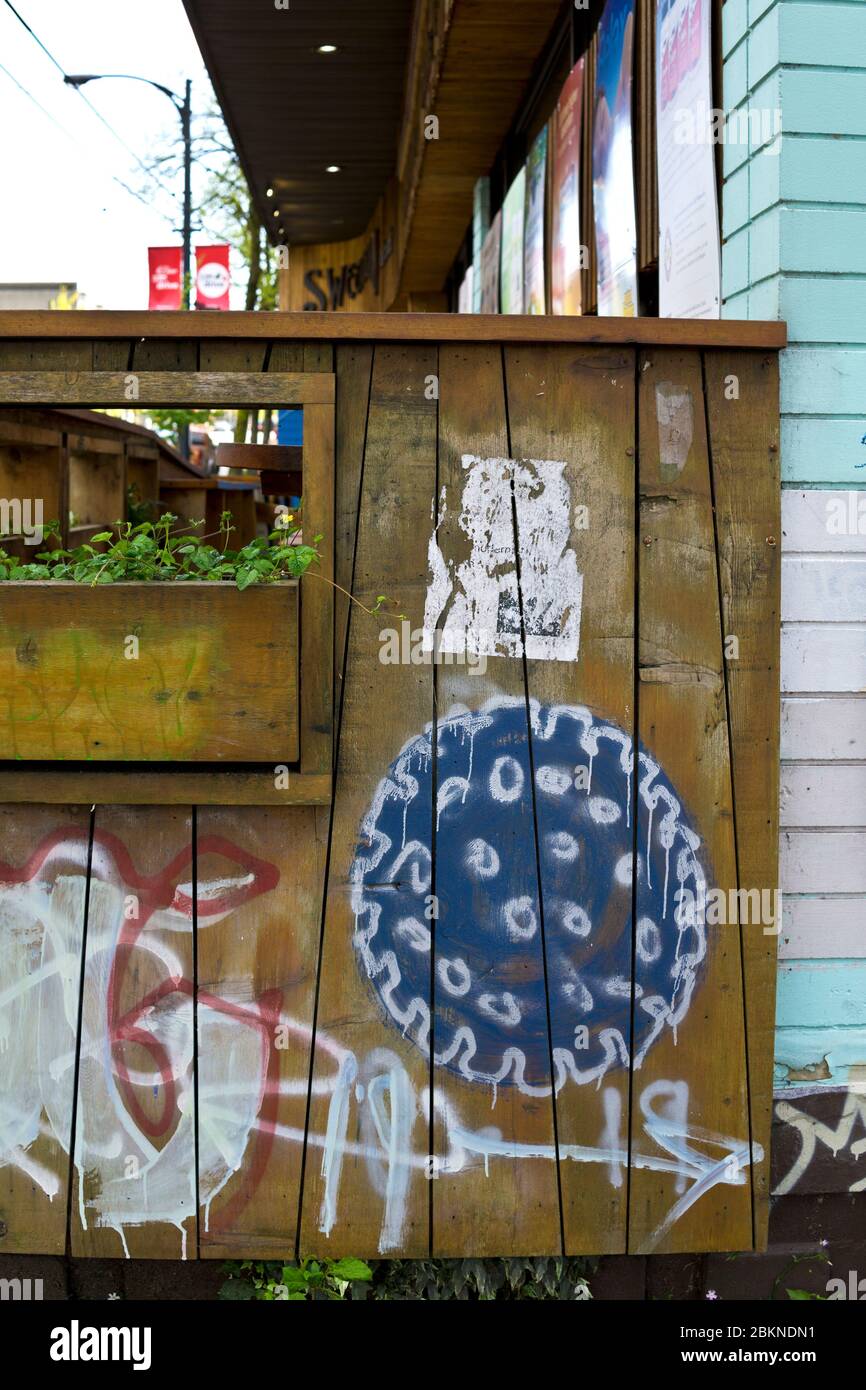 April 19, 2020: Graffiti with a drawing of the coronavirus, as seen on a restaurant patio in Vancouver, BC, Canada. Stock Photo