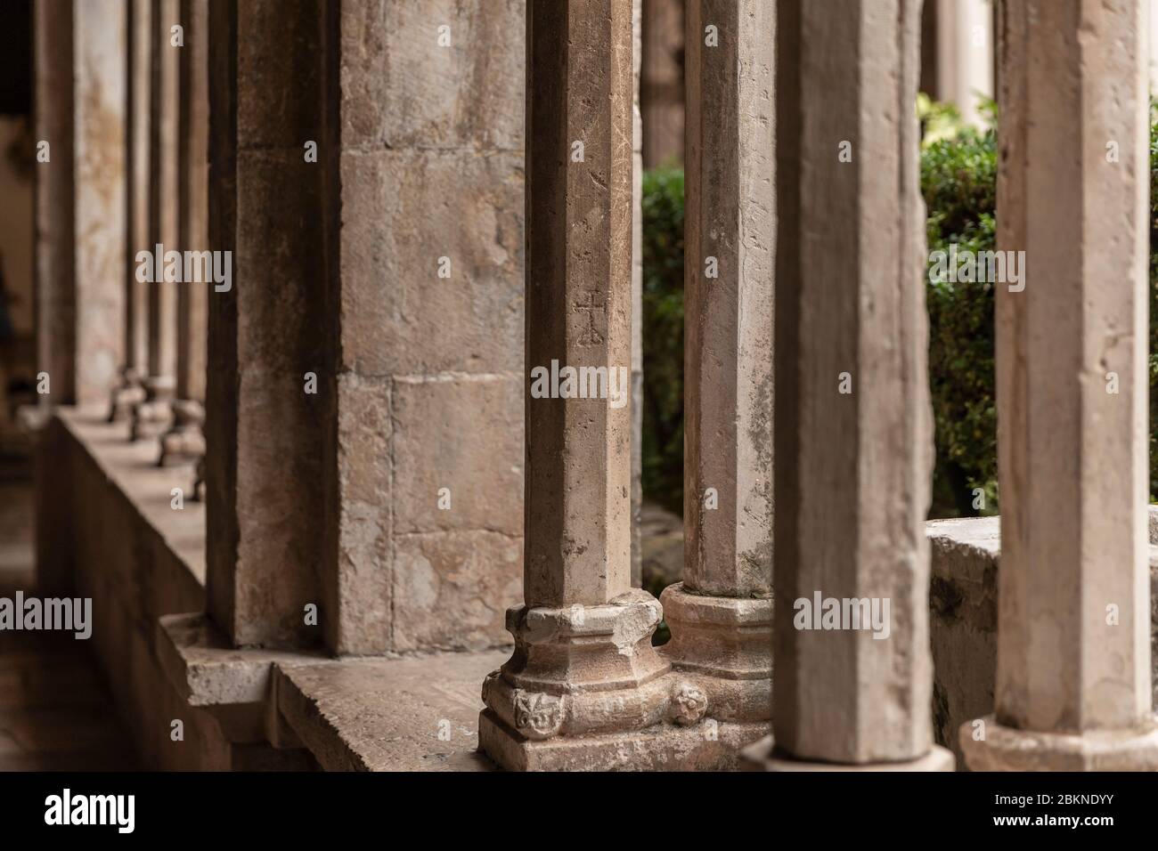 Decorative shaped columns with oranments in the 13th Century Franciscan Monastery cloister in the Old Town of Dubrovnik, Dalmatia, Croatia. Renaissanc Stock Photo