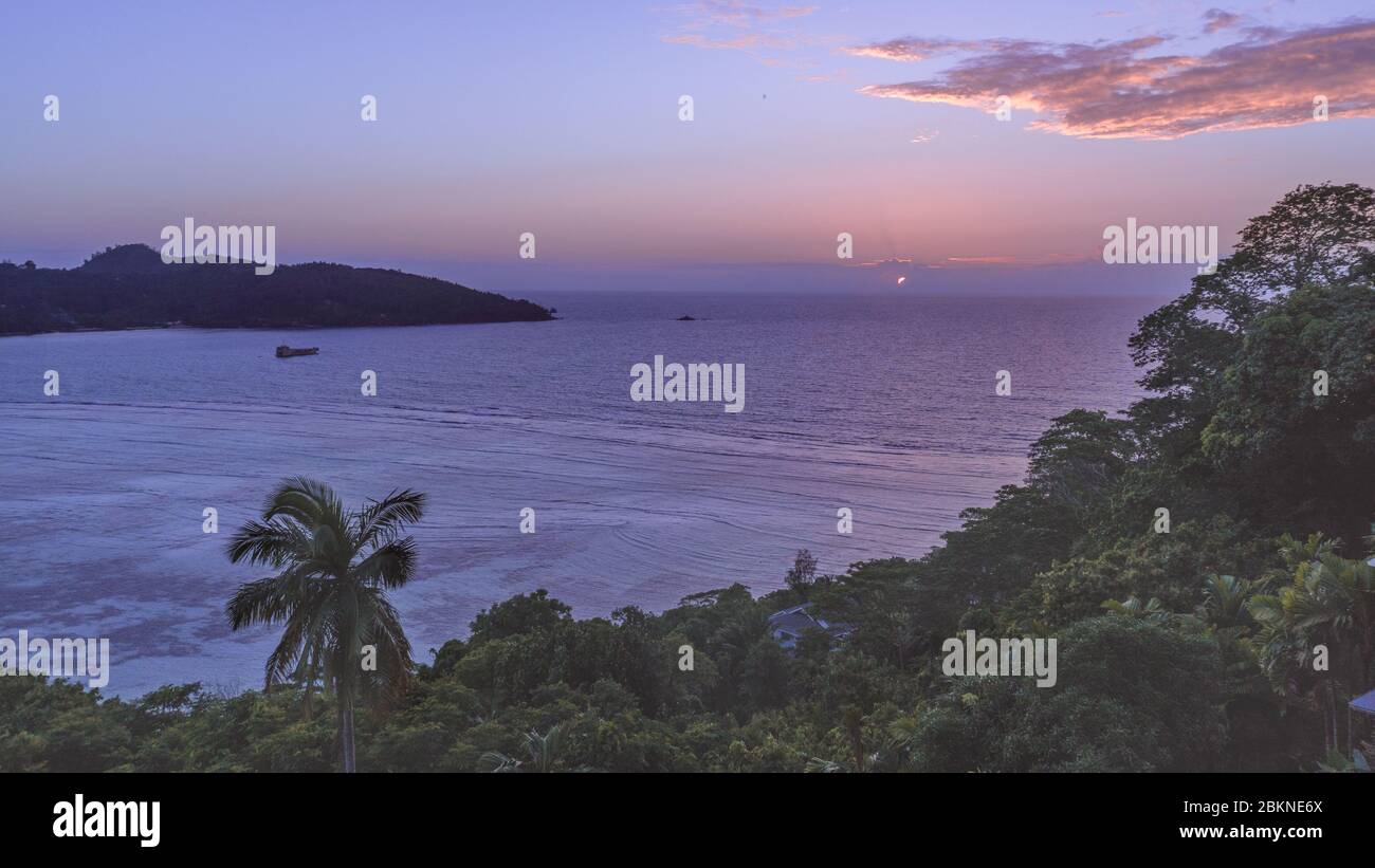 Tropical Seychelles Sunset Landscape Photo. Seychelles looking out over the Indian Ocean. Stock Photo