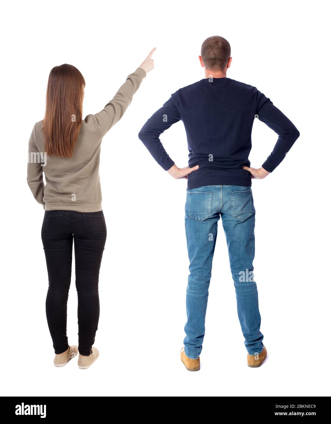 Back view of couple in sweater pointing. Rear view people collection ...