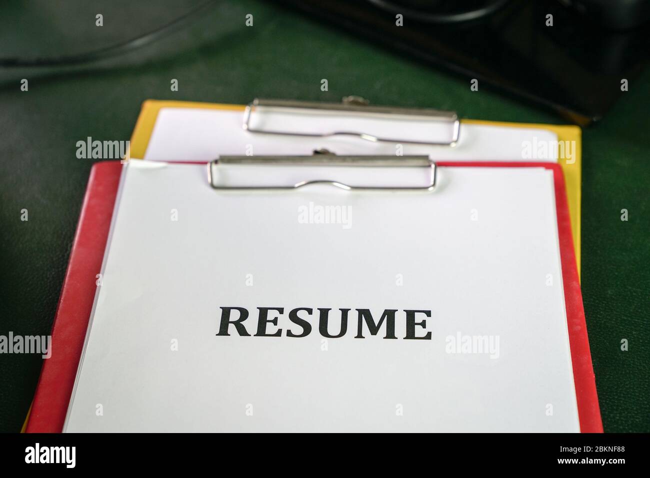 Closeup of resume on clipboard on top  of office table Stock Photo