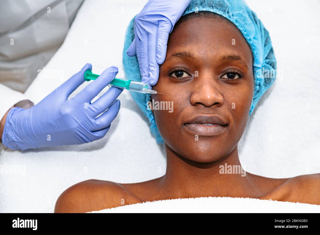 Young woman patient receiving plastic surgery injection Stock Photo