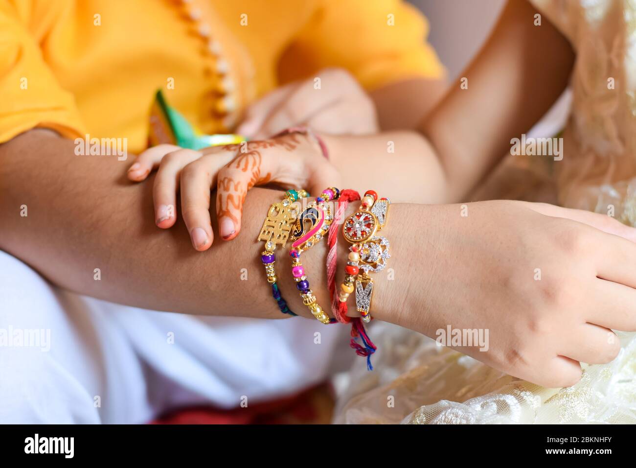 close-up shot of girl holding her brother's hand tied with Rakhi on the occasion of Raksha Bandhan Stock Photo