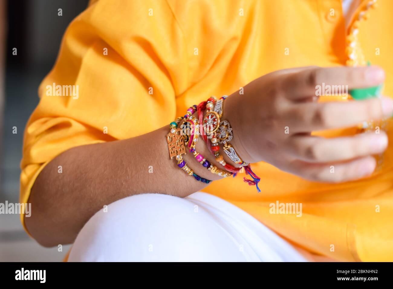 Rakhi tied on the wrist of a boy Stock Photo