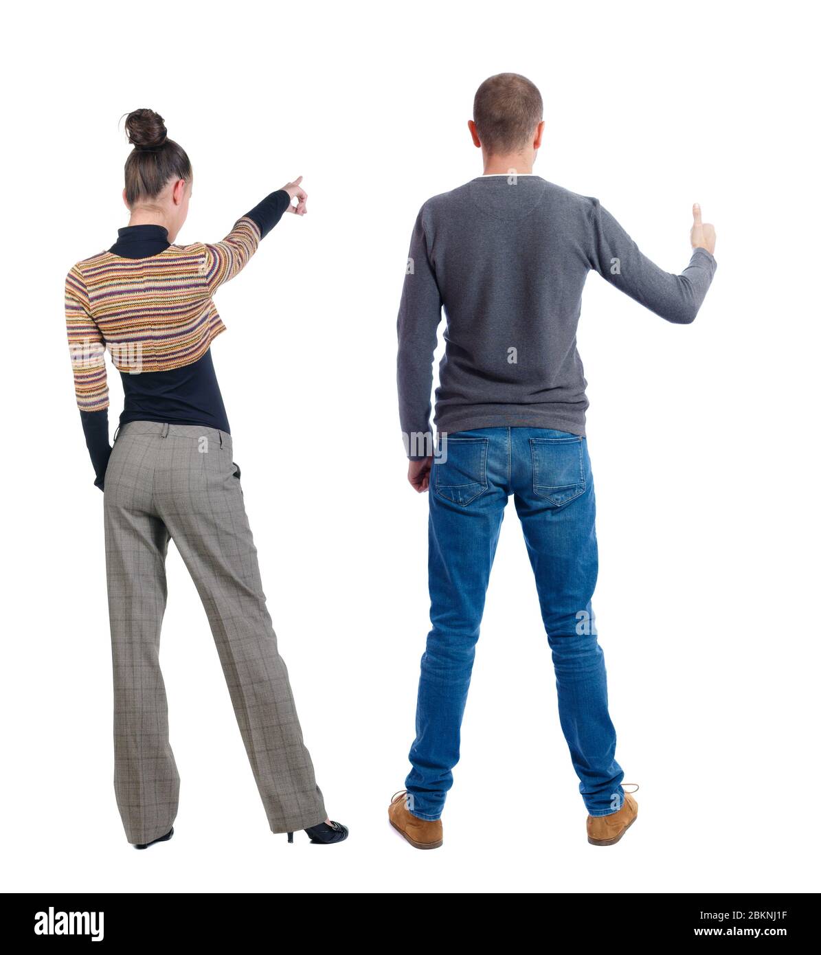 Back view of couple in sweater pointing. Rear view people collection ...