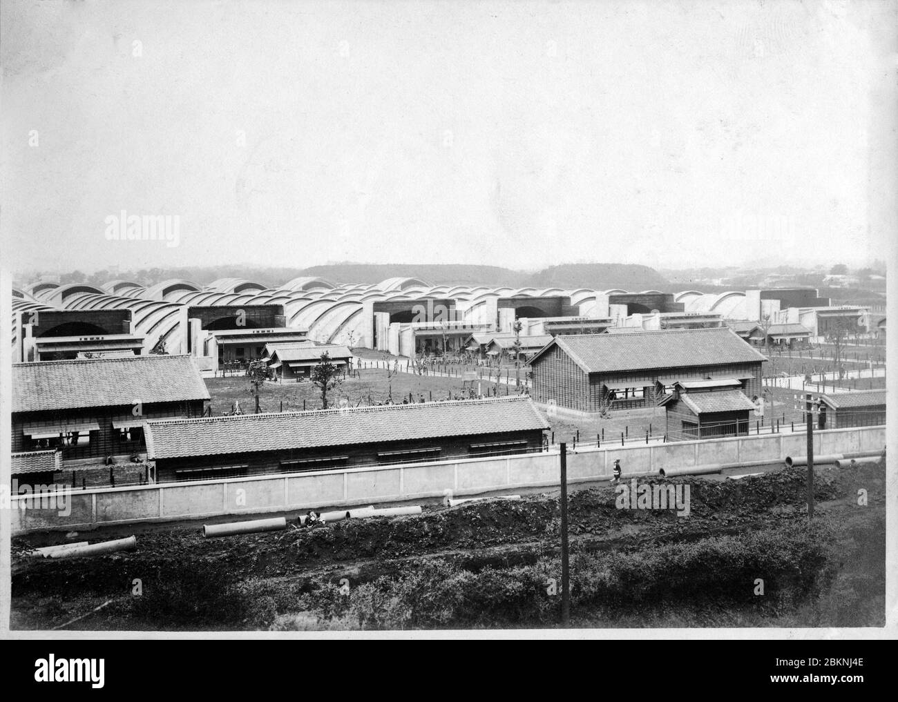 [ 1920s Japan - Japanese Military Firing Range ] —   Panoramic view of the Toyama Firing Range (戸山射撃場, Toyama Shagekijo) in Okubo (大久保), Tokyo. It was used by the Imperial Guard.   It consisted of seven 300 meter long reinforced concrete buildings into which soldiers shot their automatic and other weapons.  From a private photo album of a member of the Japanese Imperial Guard (Konoe Shidan) who served between 1928 (Showa 3) and 1930 (Showa 5).  20th century gelatin silver print. Stock Photo