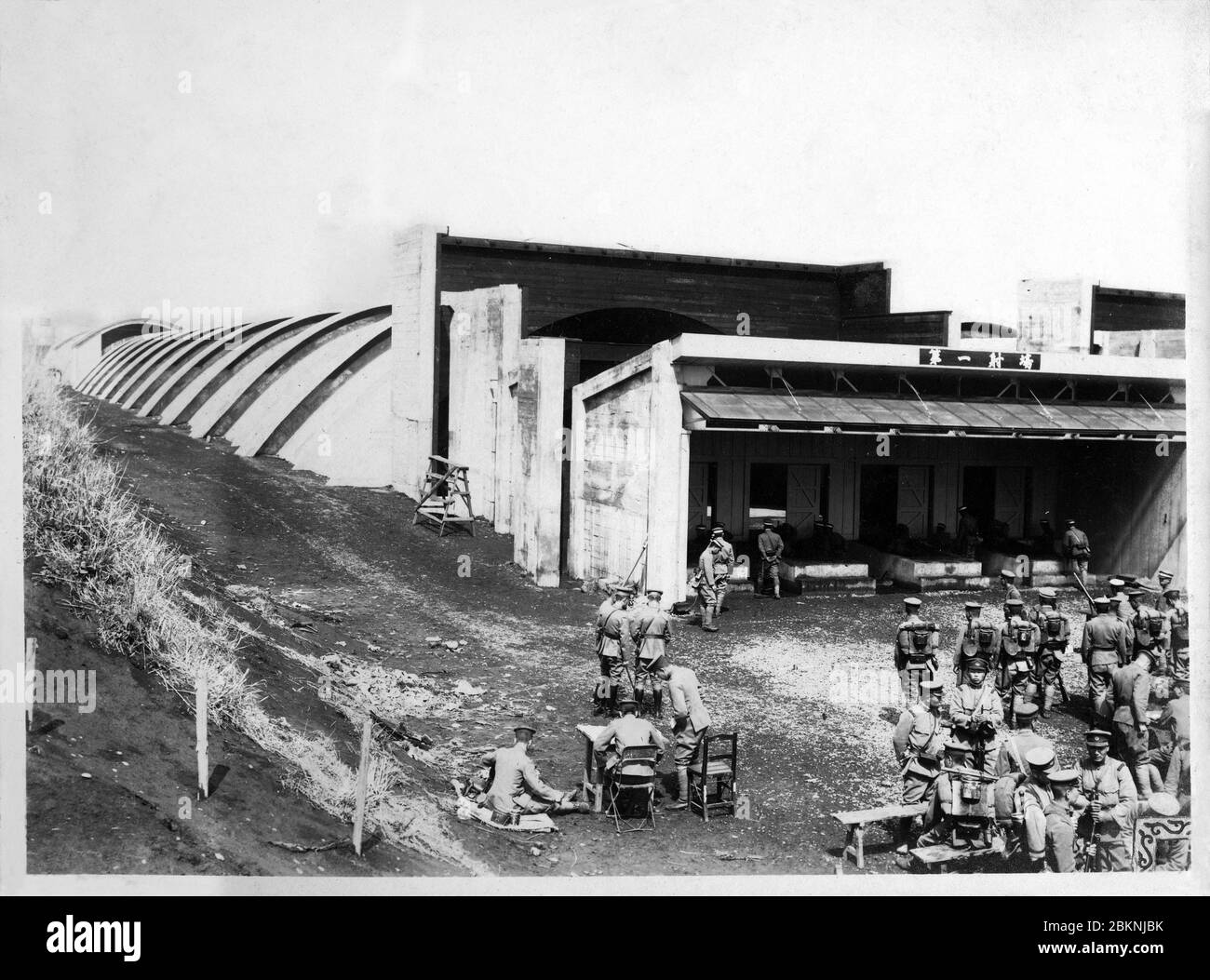 [ 1920s Japan - Japanese Military Firing Range ] —   Soldiers exercising at the Toyama Firing Range (戸山射撃場, Toyama Shagekijo) in Okubo (大久保), Tokyo. It was used by the Imperial Guard.   It consisted of seven 300 meter long reinforced concrete buildings into which soldiers shot their automatic and other weapons.  From a private photo album of a member of the Japanese Imperial Guard (Konoe Shidan) who served between 1928 (Showa 3) and 1930 (Showa 5).  20th century gelatin silver print. Stock Photo