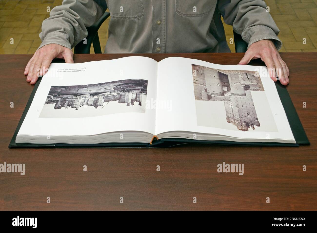 Man looking at old pictures book Stock Photo
