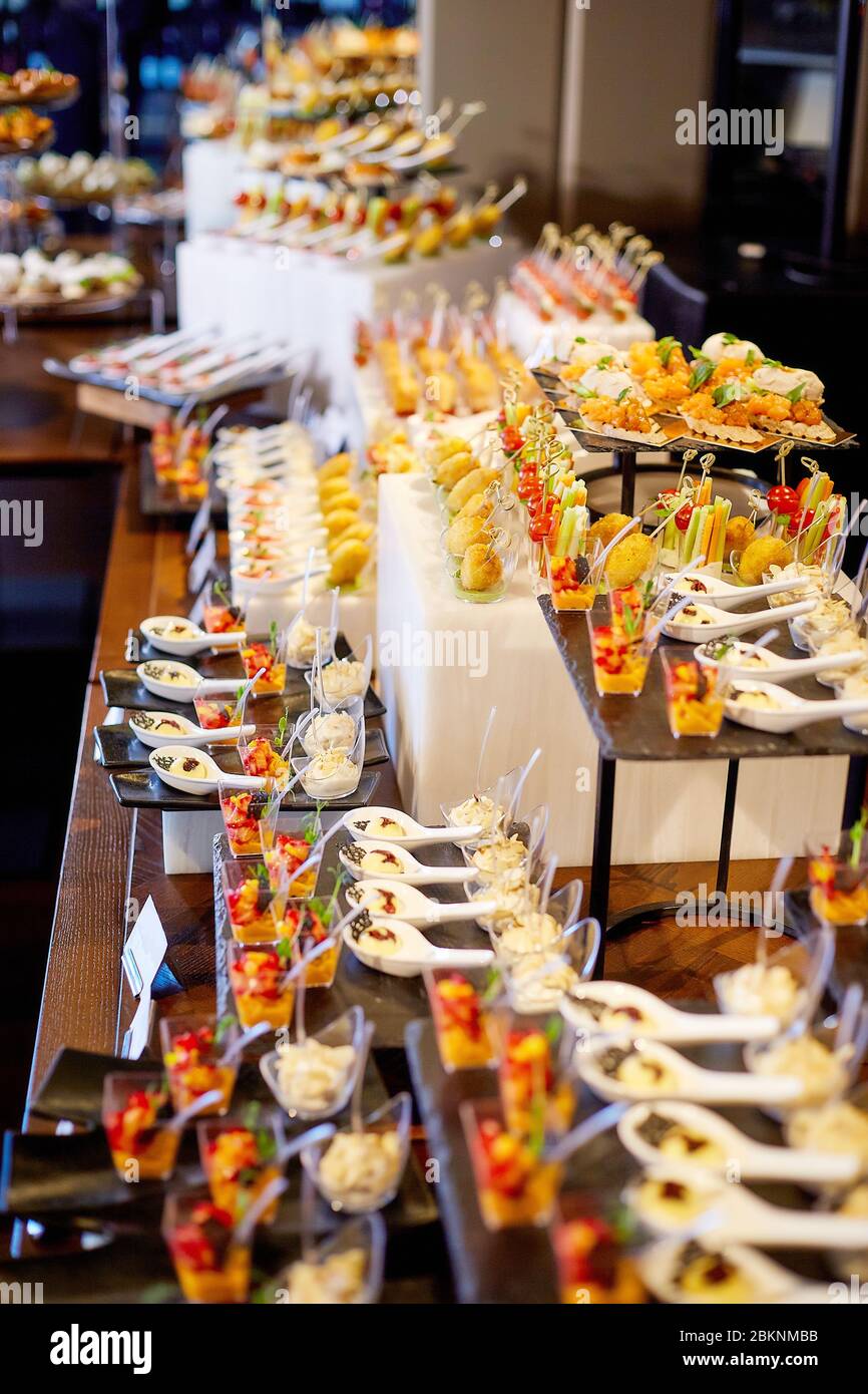 Covered buffet table with a variety of sweets and fruits standing on stands Stock Photo Alamy