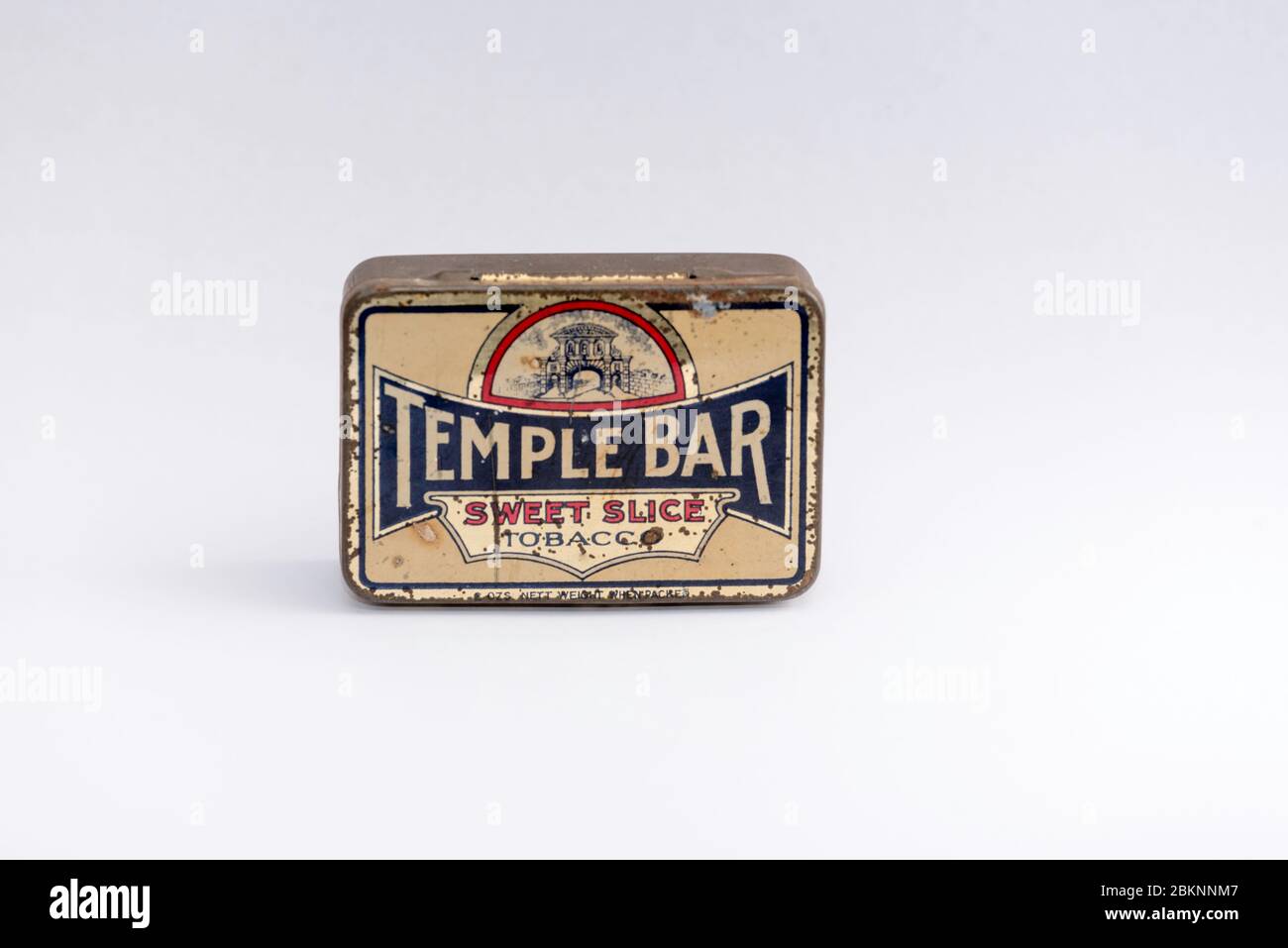 temple bar tobacco tin A still life studio image on a white background of an antique tobacco tin  with the Temple Bar sweet slice logo painted on it Stock Photo
