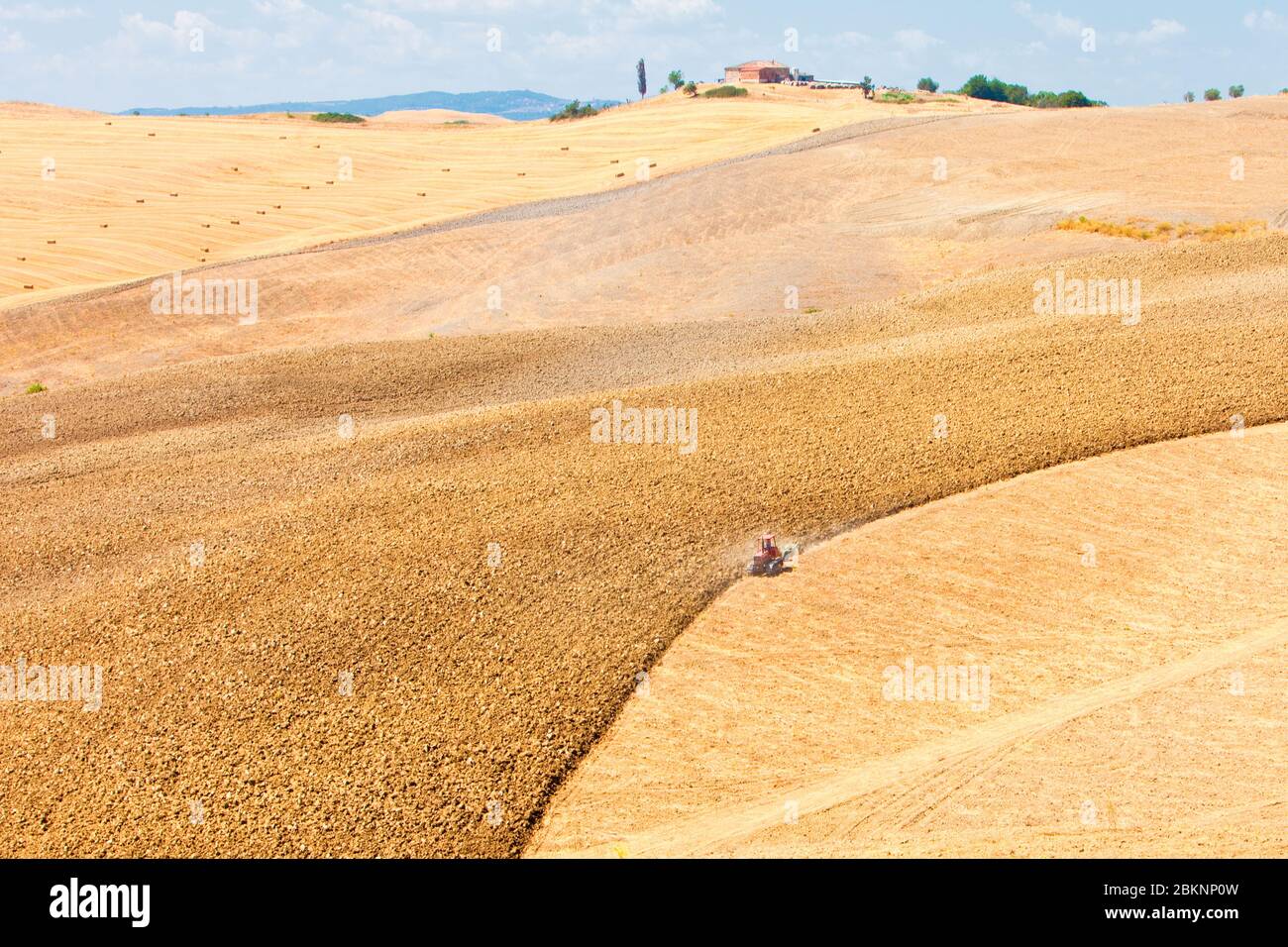 Italy Tuscany Le Crete - Agriculture - Tractor Plowing Field Stock Photo