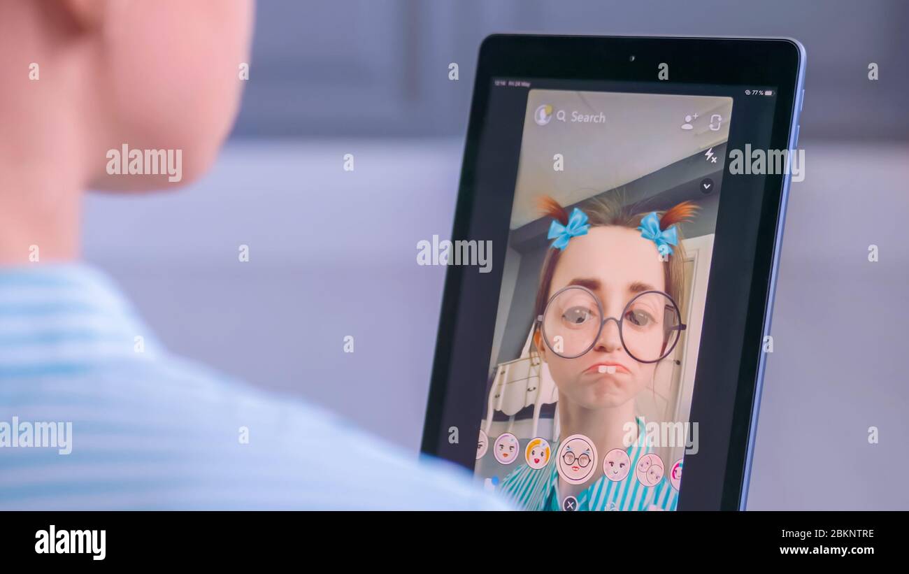 MOSCOW, RUSSIA - MAY 24, 2019: Woman using Snapchat multimedia messaging  app with 3d face mask filter on tablet at home. Face detection technology,  AR Stock Photo - Alamy