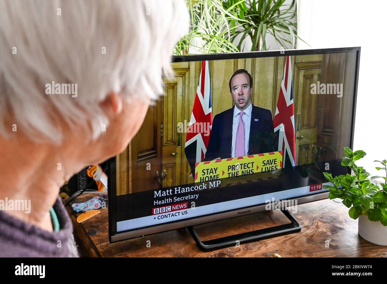 Matt Hancock, Sec of Health, giving the daily televised government Covid-19 press conference watched by a viewer. Stock Photo