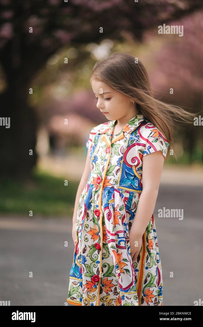 young girl model poses to photographer female kid i beautiful dress outside end of quarantine 2BKNWCE
