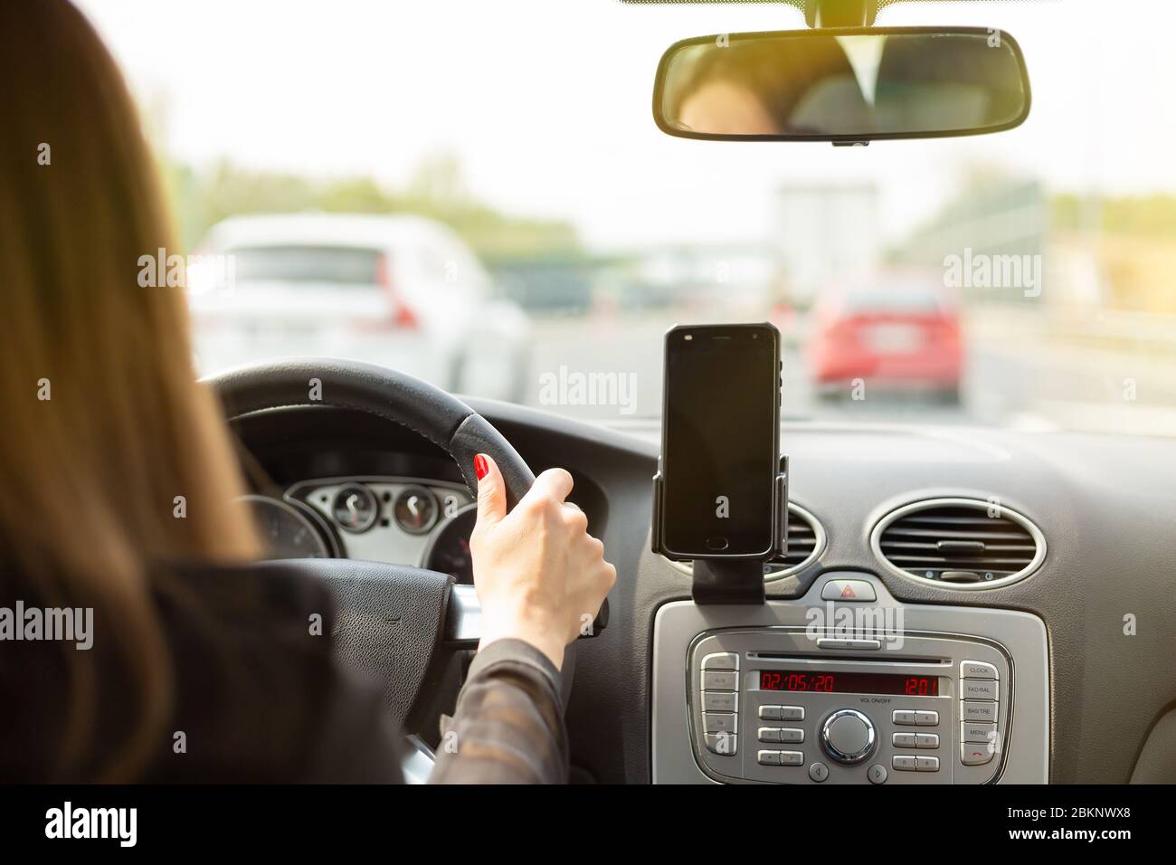 A woman driving a car on a fast road Stock Photo