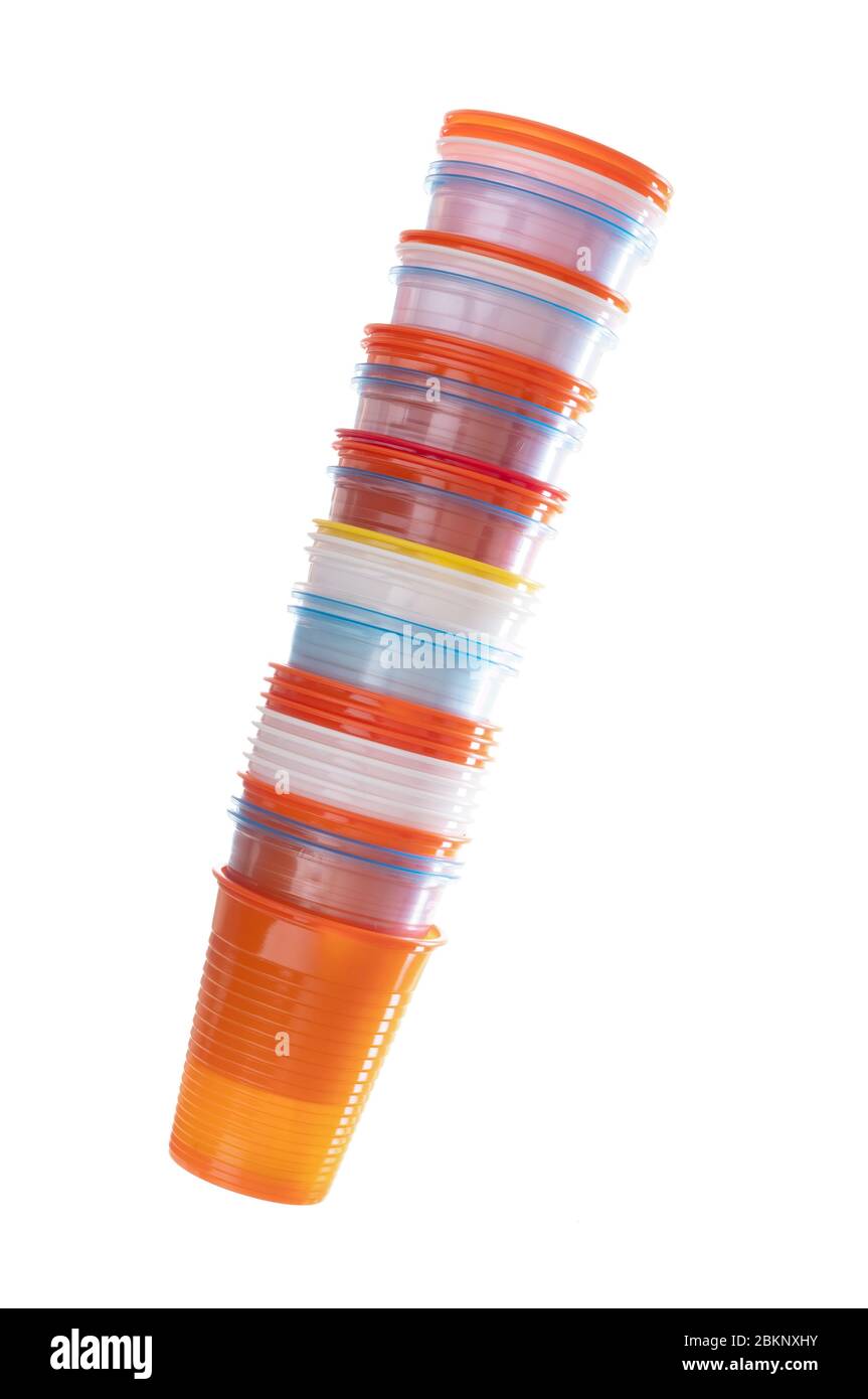Stack of assorted colourful plastic cups isolated on white background. Disposable, single use