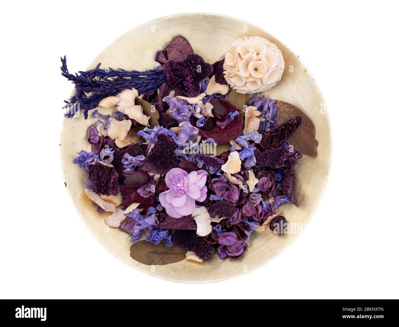 Potpourri in an old gold colour bowl, isolated on white background. Purple, mauve shades. Seen from above. Stock Photo
