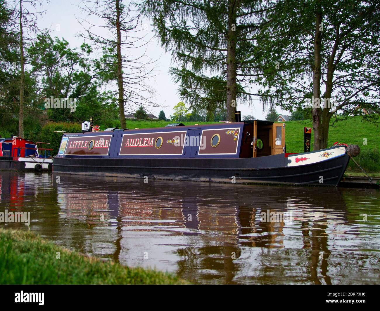 Small narrowboat called Little Bear on the canal at Audlem, Cheshire UK Stock Photo