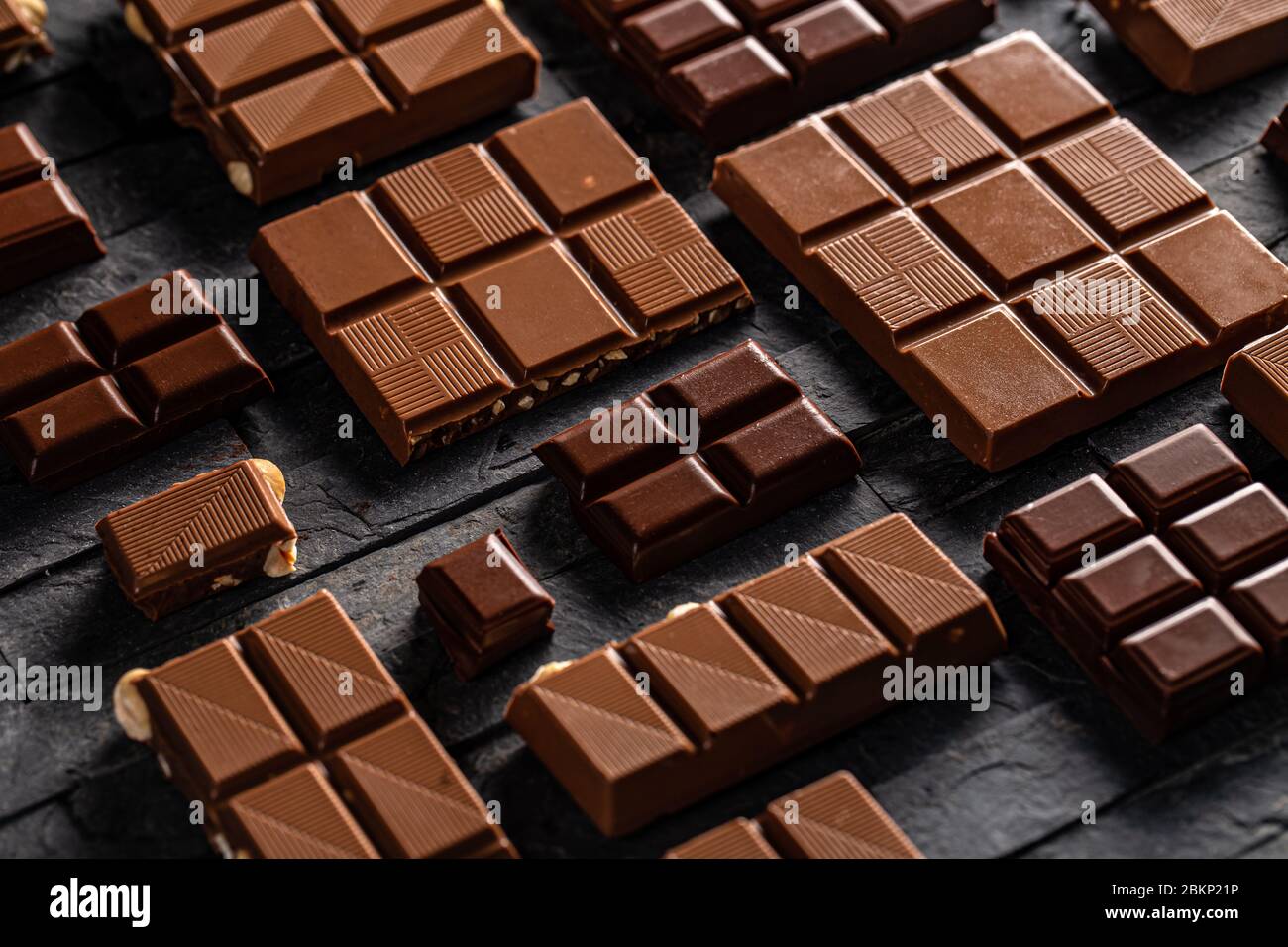 Sweet tasty milk chocolate bar on black background Stock Photo