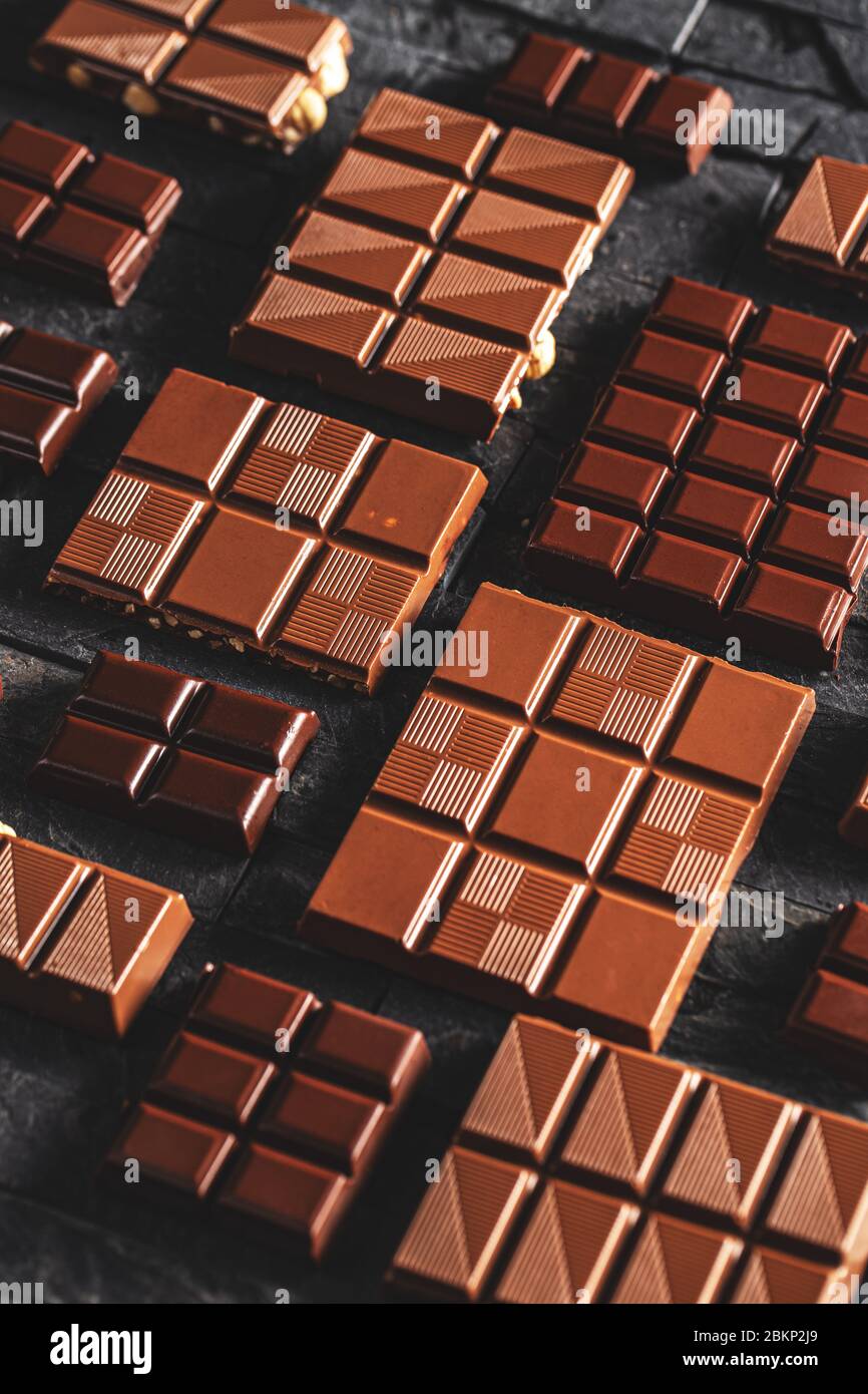 Chocolate bar pieces. Chocolate photo concept on black background Stock Photo