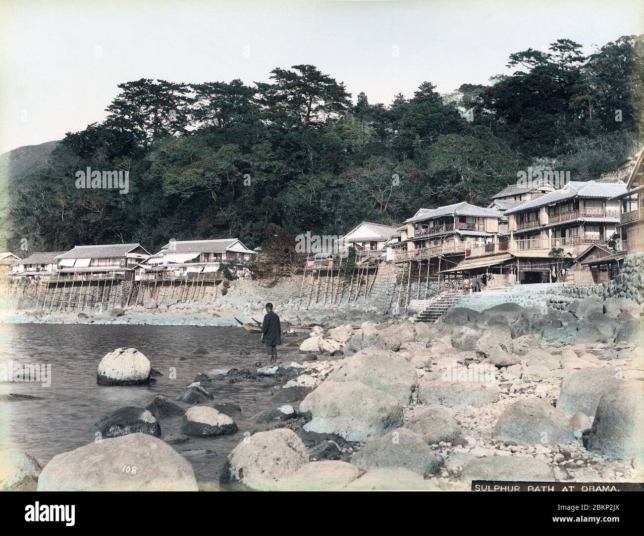 [ 1890s Japan - Inns at Japanese Hot Spring Village ] —   Ryokan (Japanese inns) at Obama Onsen (spa), in Nagasaki Prefecture, ca. 1880s. It was formerly part of Hizen Province.  Established in 713, Obama had inns built along the narrow coast line. It became very popular during the Meiji Period. Obama still is a spa resort today and has the hottest and most active springs in Japan.  19th century vintage albumen photograph. Stock Photo