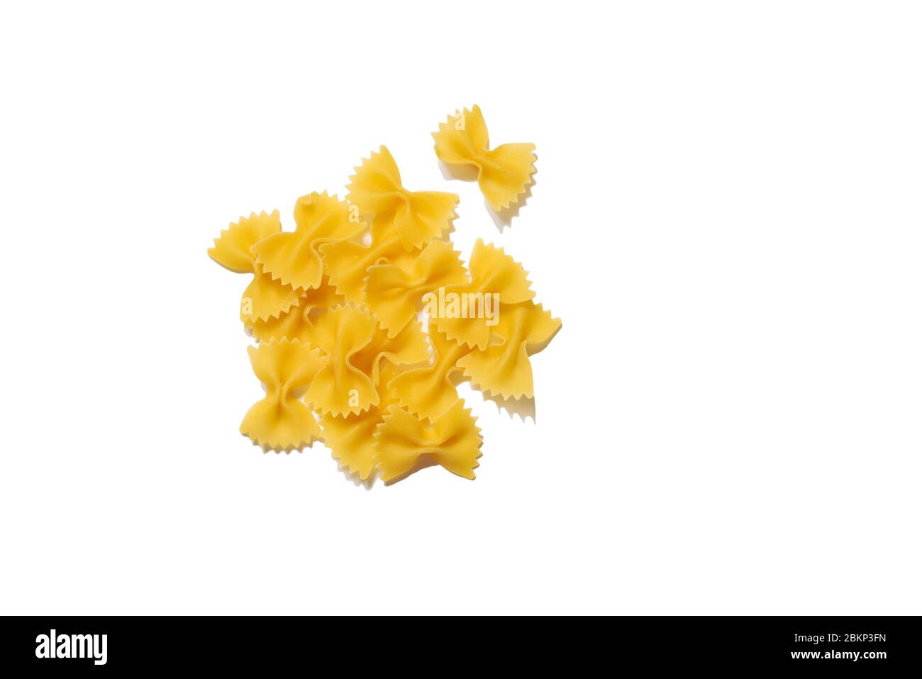 Raw organic farfalle pasta Pieces of traditional Italian farfalle pasta isolated on white bachground. Italian Cuisine. Bow tie noodles. Uncooked pasta Stock Photo